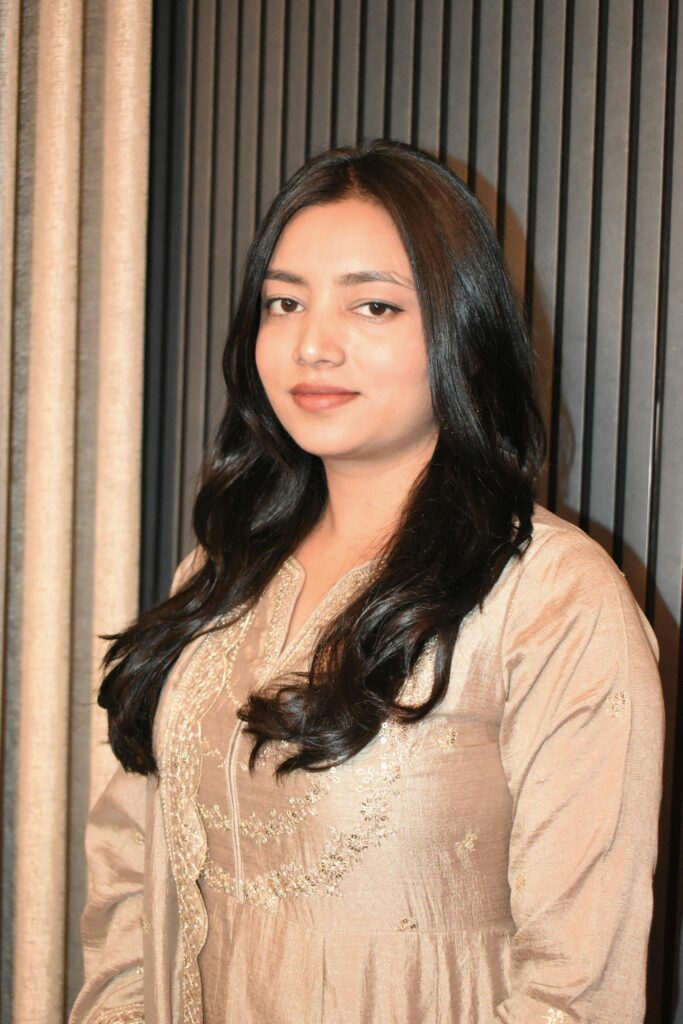 Portrait of a woman in traditional attire with a serene expression, indoors.